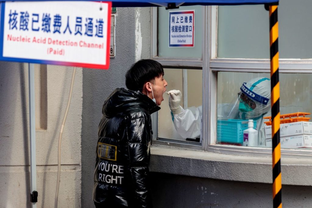 Young Chinese man being tested for Covid