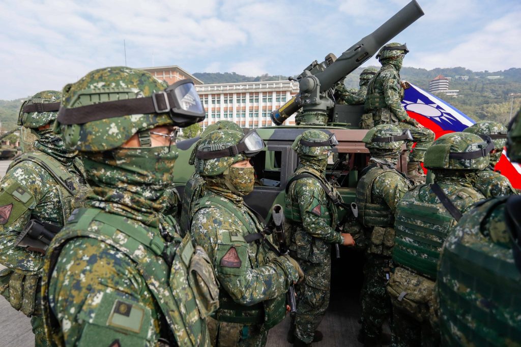 Kaohsiung, Kaohsiung, Taiwan: Army soldiers holding a Taiwanese flag stand guard at a base during a military drill simulating defence operations against a possible Chinese PLA intrusion on Jan 11, 2023 in Kaohsiung. United States military officials and international political experts have recently warned that the possibility of a war between China and the United States has increased, amid rising tensions in the Taiwan Strait where Chinese PLA presence has strengthened. Kaohsiung Taiwan - ZUMAs313
