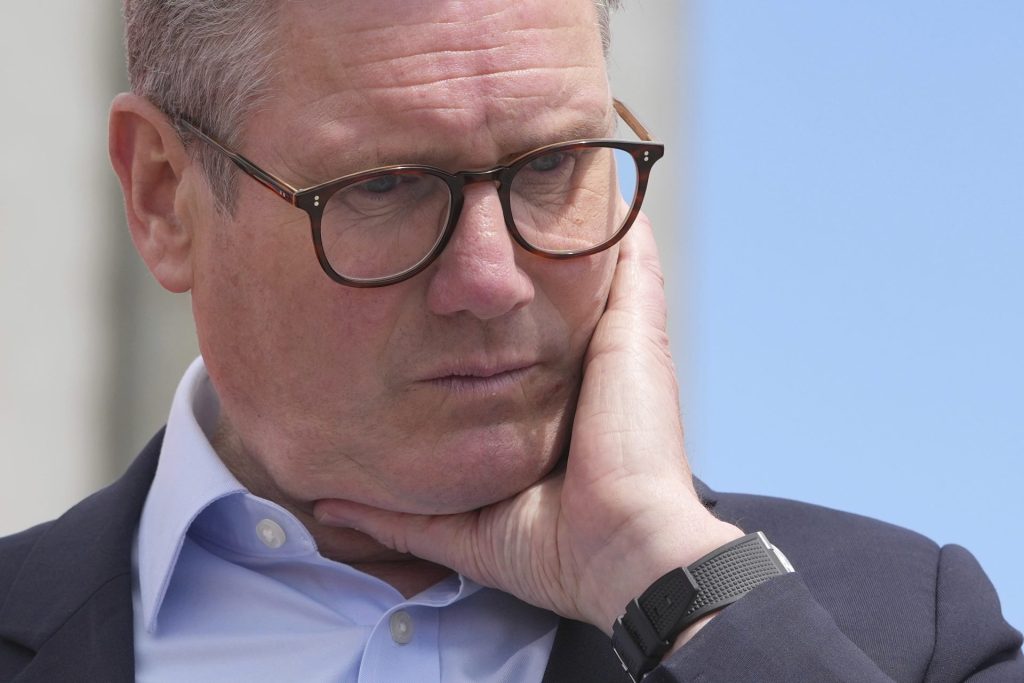 Labour Party leader Keir Starmer listens to a question from port workers during a general election campaign event Southampton Docks in Southampton, England, Monday, June 17, 2024.