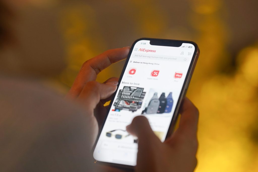 In this photo illustration, A woman browses AliExpress on her smartphone for online shopping (Photo by Serene Lee / SOPA Images/Sipa USA)