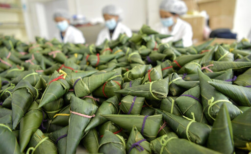 ENSHI, CHINA - MAY 31: Employees vacuum pack rice dumplings at a food company before the Dragon Boat Festival on May 31,