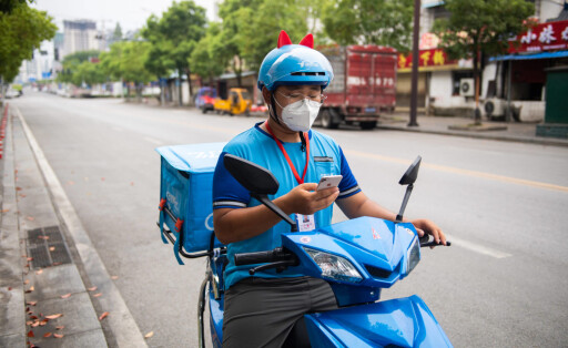 (210809) -- ZHANGJIAJIE, Aug. 9, 2021 -- Delivery man Yan Yingzhao checks orders in Yongding District of Zhangjiajie, ce