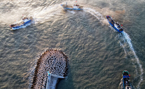 210816 -- FUZHOU, Aug. 16, 2021 -- Aerial photo taken on Aug. 16, 2021 shows fishing boats sailing from a port in Pinghai Town of Putian City, southeast China s Fujian Province. A three-and-a-half-month seasonal fishing ban on the sea area of the province was lifted on Monday. CHINA-FUJIAN-FISHING BAN-LIFT CN WeixPeiquan PUBLICATIONxNOTxINxCHN