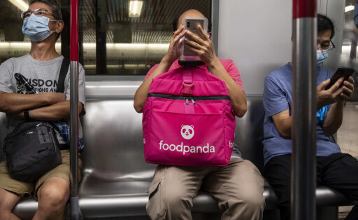 July 30, 2021, Hong Kong, China: A delivery worker from a take out food delivery company, Food Panda is seen holding a f