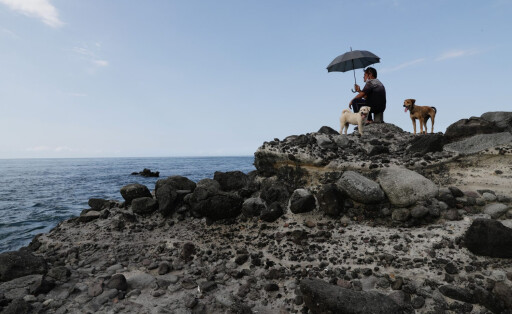 epaselect epa10105225 People look towards the location where the Chinese military believed to conduct a live fire drill from the coast of New Taipei city, Taiwan, 04 August 2022. After the visit of US house Speaker Nancy Pelosi in Taiwan, the Chinese military started a series of live-fire drills in six maritime areas near Taiwan from 04 - 07 August 2022. EPA-EFE/RITCHIE B. TONGO