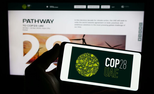 Person holding smartphone with logo of UN climate change conference COP28 Dubai on screen. Stuttgart, Germany - 03-25-2023: Person holding smartphone with logo of UN climate change conference COP28 Dubai on screen in front of website. Focus on phone display. Copyright: xZoonar.com/TimonxSchneiderx 20081770