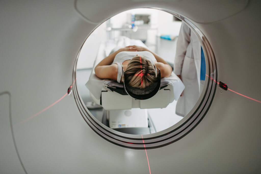 Patient positioned for head scan with laser alignment in CT scanner