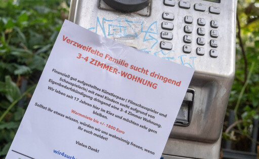Desperate housing request hangs on a broken public phone.