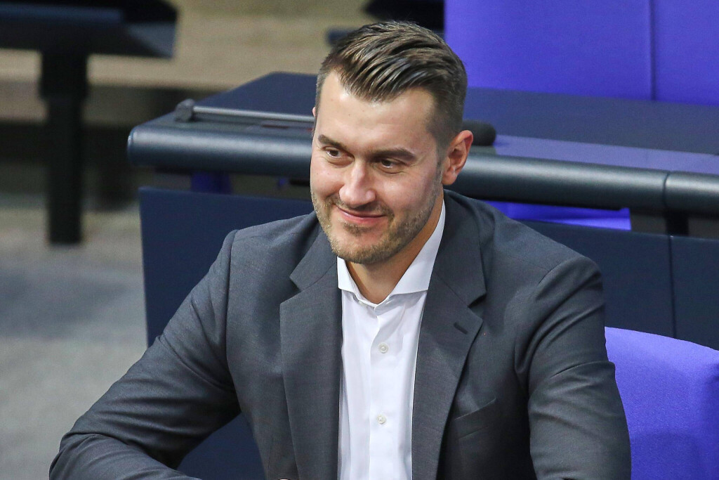 Grünen-MdB sitzt im Plenarsaal des Bundestags.