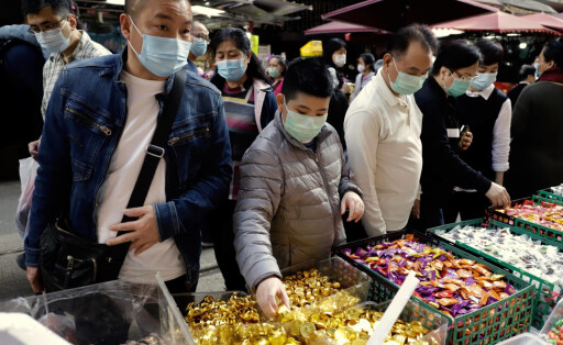 February 3, 2021, Hong Kong, CHINA: Citizens patronizing candy vendor on the street market as celebration of Chinese New