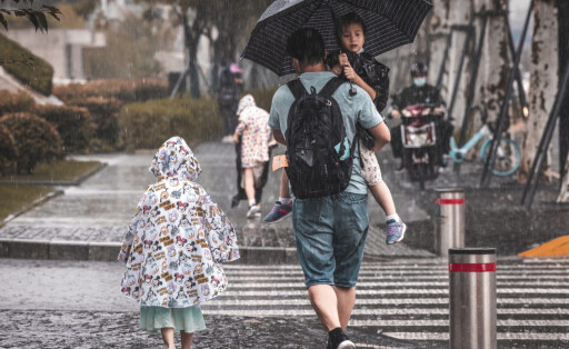 epa09416192 People walk on a heavy rain in Shanghai, China, 16 August 2021. China’s economy continued to slow down in July, with the unemployment rate slightly increased to 5.1percent from 5 percent in June, according to the National Bureau of Statistics data released on 16 August. Industrial production and retail sales grew by 6.4 percent and 8.5 percent year-on-year, while the fixed-asset investment grew by 10.3 percent in January-July. China’s newly built house prices rose by 4.6percent year-on-year in July 2021. EPA-EFE/ALEX PLAVEVSKI