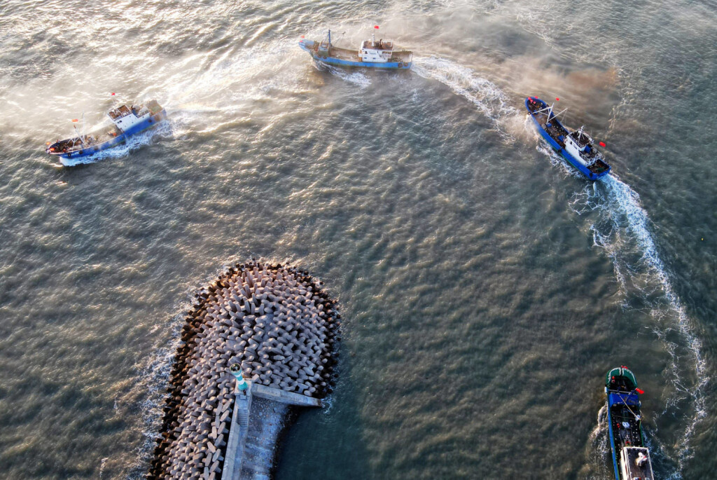 210816 -- FUZHOU, Aug. 16, 2021 -- Aerial photo taken on Aug. 16, 2021 shows fishing boats sailing from a port in Pinghai Town of Putian City, southeast China s Fujian Province. A three-and-a-half-month seasonal fishing ban on the sea area of the province was lifted on Monday.  CHINA-FUJIAN-FISHING BAN-LIFT CN WeixPeiquan PUBLICATIONxNOTxINxCHN