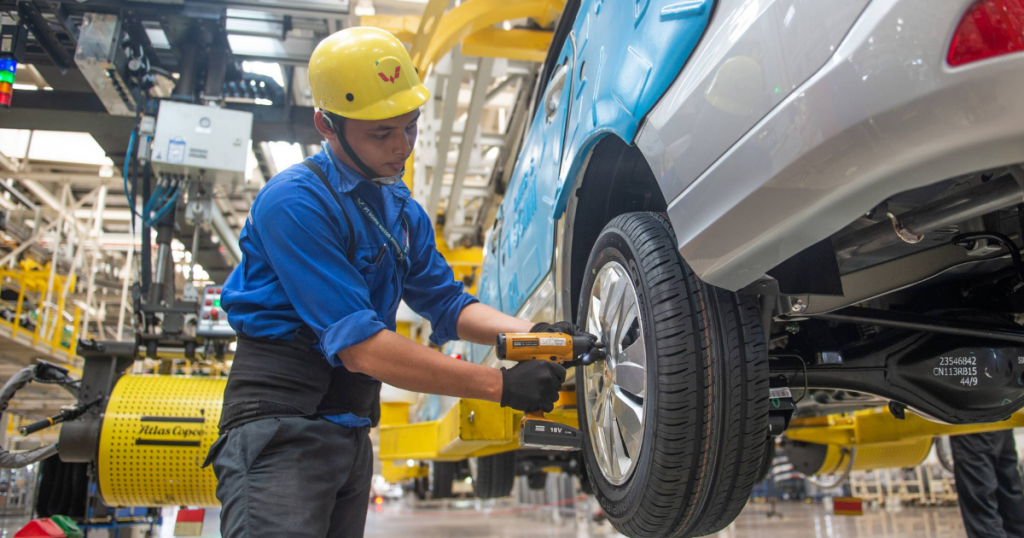 A worker assembles a vehicle at the assembly line of the SAIC-GM-Wuling Automobile (SGMW) plant