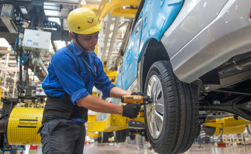 A worker assembles a vehicle at the assembly line of the SAIC-GM-Wuling Automobile (SGMW) plant