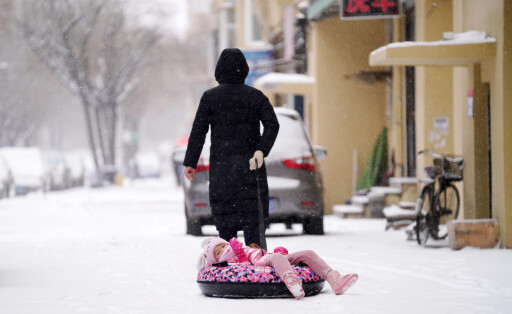211122 -- HARBIN, Nov. 22, 2021 -- People have fun in the snow in Harbin, northeast China s Heilongjiang Province, Nov. 22, 2021. Blizzards hit many parts of Heilongjiang on Monday. CHINA-HEILONGJIANG-SNOW CN WangxJianwei PUBLICATIONxNOTxINxCHN