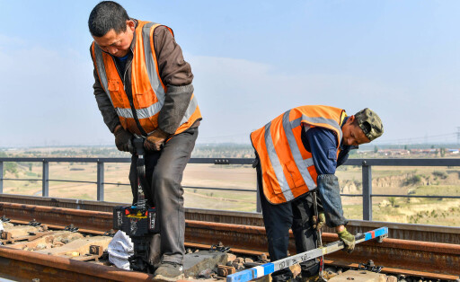 220511 -- DATONG, May 11, 2022 -- Workers maintain the Datong section of the Datong-Qinhuangdao railway in north China s Shanxi Province, May 10, 2022. An overhaul for the Datong-Qinhuangdao railway has been recently carried out on a daily basis to secure safe and smooth rail operations. The 653-km Datong-Qinhuangdao railway, which links the city of Datong in coal-rich Shanxi Province with the port city of Qinhuangdao of north China s Hebei Province, is an artery of China s coal transportation. During the overhaul time, the railway stops its service three hours a day so that construction workers are able to alter damaged rails, clean rail beds and clear silt. The maintenance work lasts for 20 days. CHINA-SHANXI-DATONG-QINHUAN PUBLICATIONxNOTxINxCHN