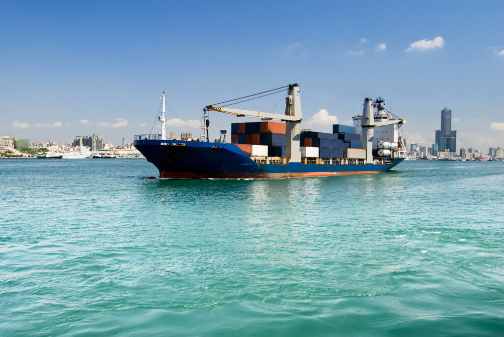 Freighter with cargo sailing on sea with blue sky and green water and beautiful cityscape of buildings and skyscraper in Kaohsiung, Taiwan. , 726350.jpg, cityscape, city, harbor, skyline, day, color, vivid, Kaohsiung, Taiwan, architecture, attractive, bay, beautiful, beauty, boats, building, business, clear, construction, dock, downtown, dramatic, exterior, famous, landmark, landscape, modern, ocean, office, outdoor, outside, scene, scenery, scenic, sea, ship, sky, skyscraper, street, structure, tall, travel, urban, view, water, boat, green, wave, freighter, horizontal,