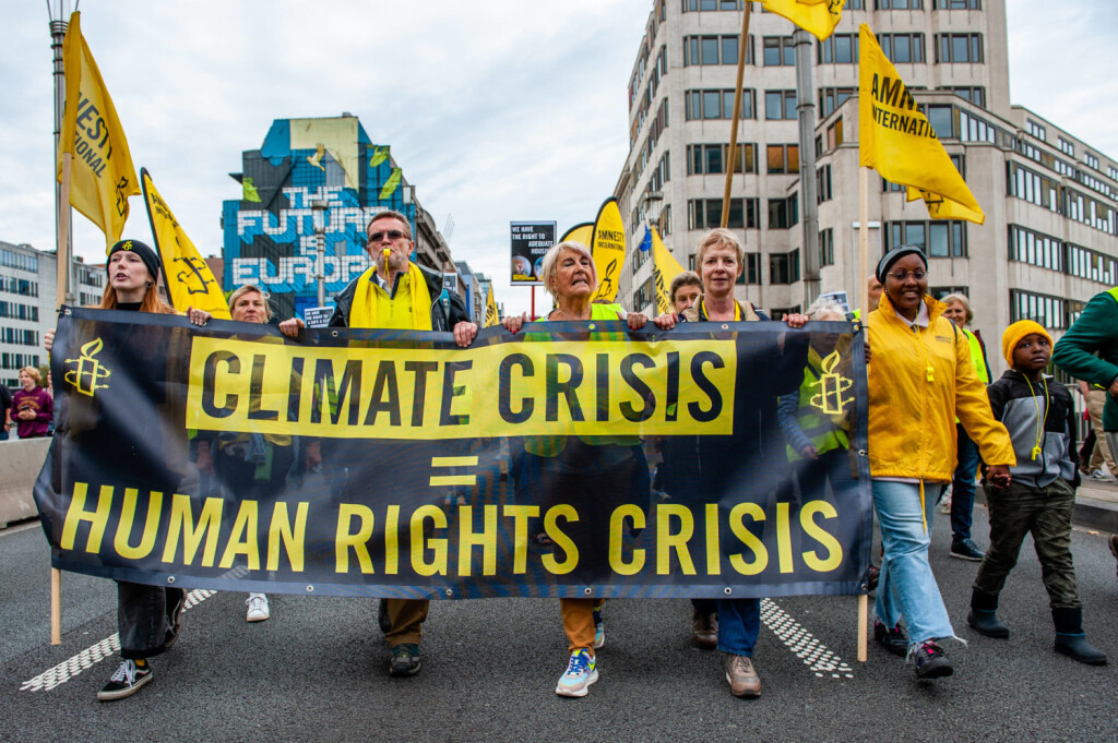 Walk For Your Future Climate March Organized In Brussels People are holding a banner from Amnesty International, during