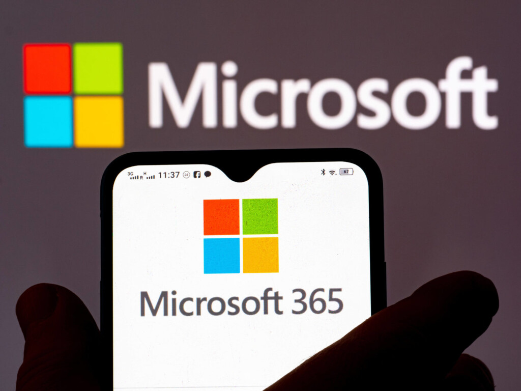 January 12, 2022, Ukraine: In this photo illustration, the Microsoft 365 logo is seen displayed on a smartphone and Micr