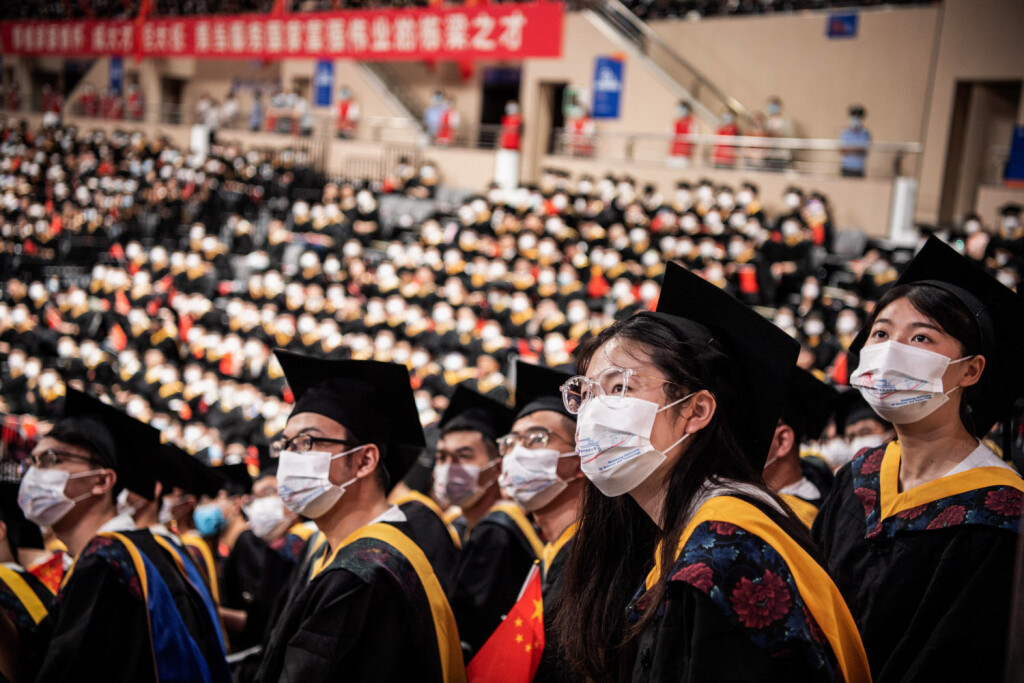 June 22, 2022, Wuhan, China: Chinese students from Huazhong University of Science and Technology seen watching a graduation short film on a big screen during the graduation ceremony at the school s gym. Over the next few weeks, China will churn out a record 10.8 million college graduates. Wuhan China - ZUMAs197 20220622_zaa_s197_135 Copyright: xRenxYongx