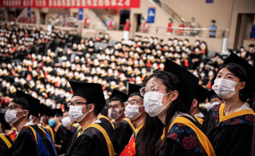 June 22, 2022, Wuhan, China: Chinese students from Huazhong University of Science and Technology seen watching a graduation short film on a big screen during the graduation ceremony at the school s gym. Over the next few weeks, China will churn out a record 10.8 million college graduates. Wuhan China - ZUMAs197 20220622_zaa_s197_135 Copyright: xRenxYongx