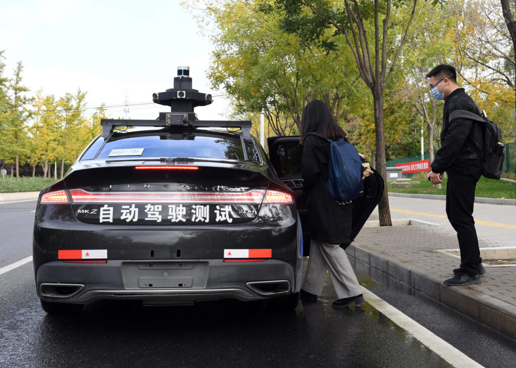 201014 -- BEIJING, Oct. 14, 2020 -- A woman takes a self-driving taxi at an appointed location on the Daoxianghu Road in Haidian District of Beijing, capital of China, Oct. 14, 2020. China s internet giant Baidu has launched a program in Beijing to offer free trials of its self-driving taxi service from Saturday. The pilot service, which serves certain stops in a part of the city from 10 a.m. to 4 p.m., will operate until Nov. 6, according to Baidu. CHINA-BEIJING-SELF-DRIVING TAXI-FREE TRIALS CN RenxChao PUBLICATIONxNOTxINxCHN