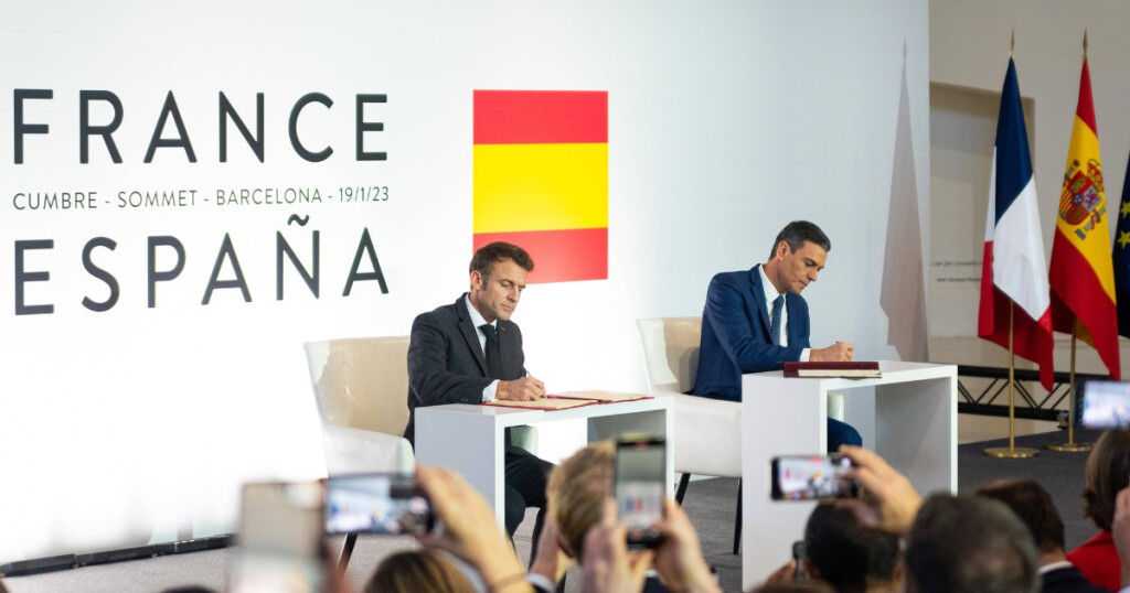 Spanish President Pedro Sanchez and French President Emmanuel Macron are seen during the signing of the agreement during the 27th Spain-France Summit