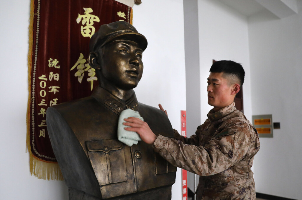230303 -- BEIJING, March 3, 2023 -- Mou Zhenhua, the 27th leader of the Lei Feng Squad, wipes the sculpture of Lei Feng in northeast China s Liaoning Province, Feb. 11, 2023. Xinhua Headlines: Sixty years on, hero soldier remains a role model in China YaoxJianfeng PUBLICATIONxNOTxINxCHN