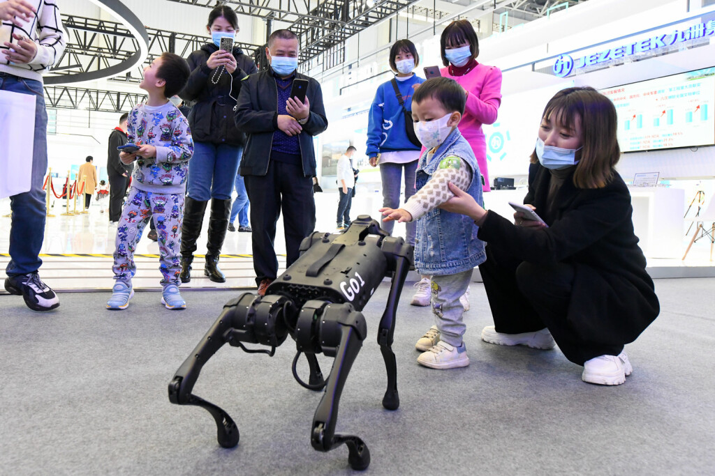 221116 -- MIANYANG, Nov. 16, 2022 -- A child interacts with a robotic dog at the 10th China Mianyang Science and Technology City International High-Tech Expo in Mianyang, southwest China s Sichuan Province, Nov. 16, 2022. The expo commenced Wednesday in the city of Mianyang. Under the theme Science and Technology Leading, Innovation and Entrepreneurship, Win-win Cooperation , the expo will see more than 600 high-tech companies and institutes participating both online and offline. CHINA-SICHUAN-MIANYANG-HIGH-TECH EXPO-EXHIBITS CN TangxWenhao PUBLICATIONxNOTxINxCHN