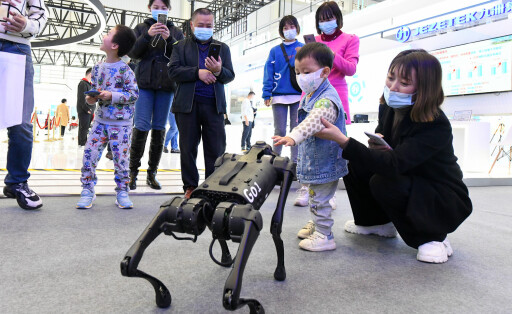 221116 -- MIANYANG, Nov. 16, 2022 -- A child interacts with a robotic dog at the 10th China Mianyang Science and Technology City International High-Tech Expo in Mianyang, southwest China s Sichuan Province, Nov. 16, 2022. The expo commenced Wednesday in the city of Mianyang. Under the theme Science and Technology Leading, Innovation and Entrepreneurship, Win-win Cooperation , the expo will see more than 600 high-tech companies and institutes participating both online and offline. CHINA-SICHUAN-MIANYANG-HIGH-TECH EXPO-EXHIBITS CN TangxWenhao PUBLICATIONxNOTxINxCHN