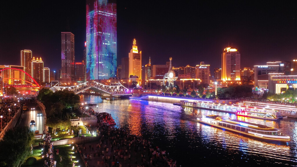 (190809) -- BEIJING, Aug. 9, 2019 -- Aerial photo taken on July 1, 2019 shows the opened Jiefang Bridge in Tianjin, north China. Nighttime economy has become a hot word this summer. It refers to business activities between 6 p.m. and 6 a.m. in the service sector. Many Chinese cities, especially metropolises such as Beijing, Shanghai and Guangzhou, have rolled out plans to support nighttime consumption to drive economic growth. China s GDP grew by 6.3 percent in the first half of this year, and consumption accounted for 60 percent, which continued to be the first driving force for the country s economic growth. Among them, nighttime consumption shows giant potential, according to the National Bureau of Statistics. Nighttime economy has become a new engine to enhance the city s vitality and promote China s development. It meets peo PUBLICATIONxNOTxINxCHN