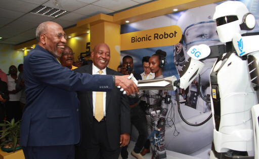 200117 -- KAMPALA, Jan. 17, 2020 -- Uganda s Prime Minister Ruhakana Rugunda L, Front shakes hands with a robot that uses the 5G network during a 5G technology trial ceremony in Kampala, capital of Uganda, on Jan. 17, 2020. China s ZTE and MTN Uganda on Friday started 5G technology trial here to be the first who brings the Standalone 5G network into reality in east Africa as the region awaits it commercial roll out. Photo by Zhang Gaiping/Xinhua UGANDA-KAMPALA-MTN UGANDA-CHINA-ZTE-5G TRIAL ZhangxGaipingdaixiugai PUBLICATIONxNOTxINxCHN