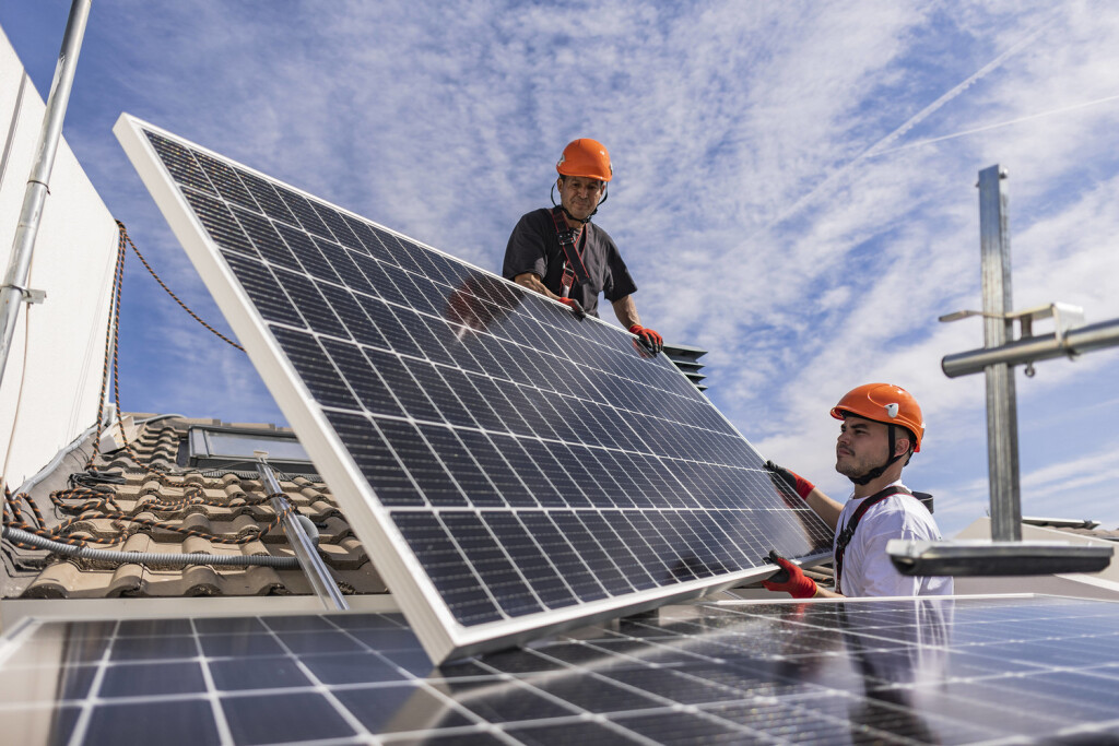 Engineers together installing solar panels model released, Symbolfoto property released, JCCMF10076