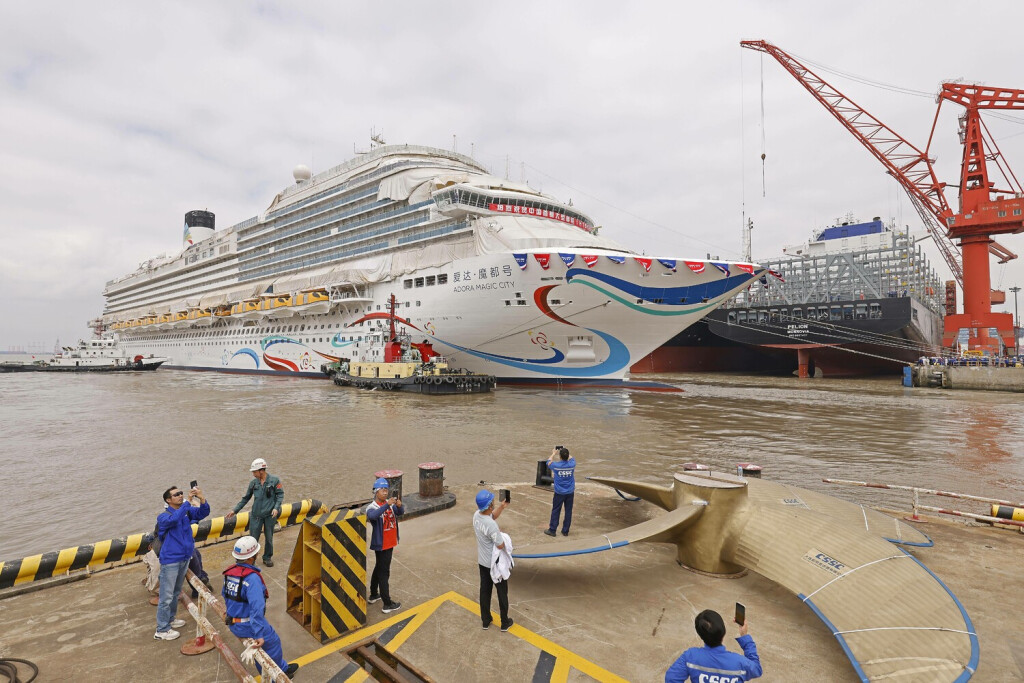 SHANGHAI, CHINA - JUNE 06: People take photos during the launching ceremony of China s first domestically-built large cruise ship Adora Magic City at a shipyard of Shanghai Waigaoqiao Shipbuilding Co., Ltd on June 6, 2023 in Shanghai, China. The cruise ship, measuring 323.6 meters in length and 37.2 meters in width with a gross tonnage of 135,500 tonnes, can accommodate a total of 5,246 passengers. PUBLICATIONxINxGERxSUIxAUTxHUNxONLY Copyright: xChinaxNewsxServicex 111439964928