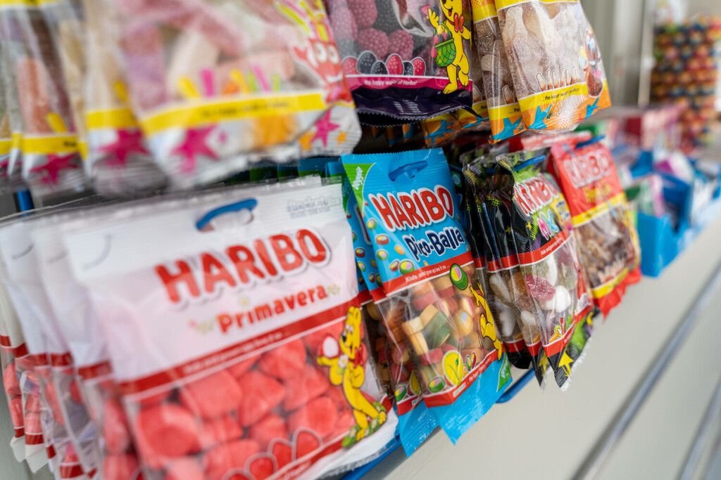 Mykonos, Greece - 10 May 2023: Packs of Haribo gummy bears candy hanging on a kiosk *** Packungen Haribo Gummibärchen Süßigkeiten hängen an einem Kiosk